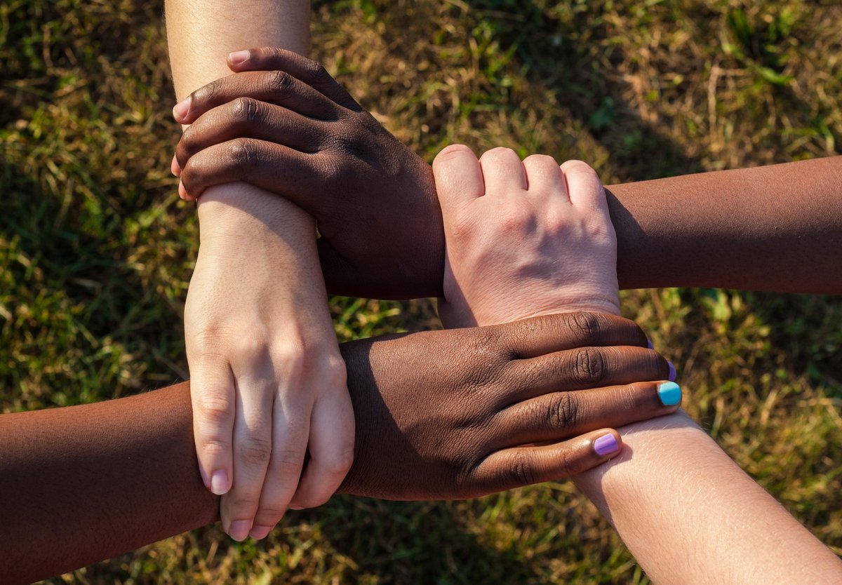 Diverse hands together in unity and support